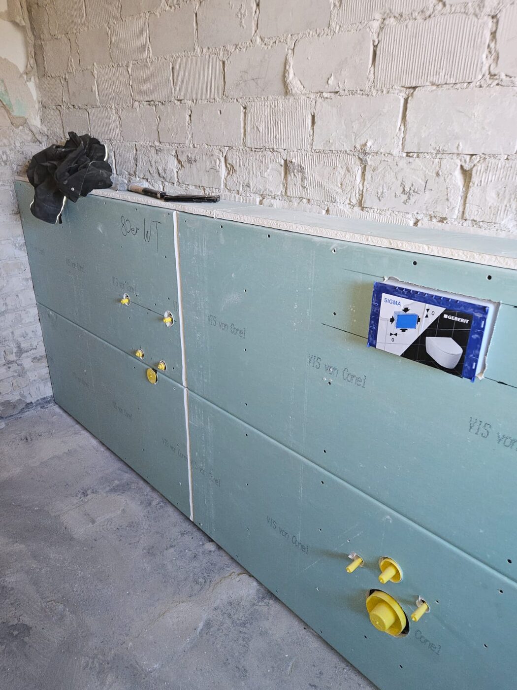 Beplankte Vorwand mit vorbereiteten Anschlüssen für Waschtisch und Wand-WC